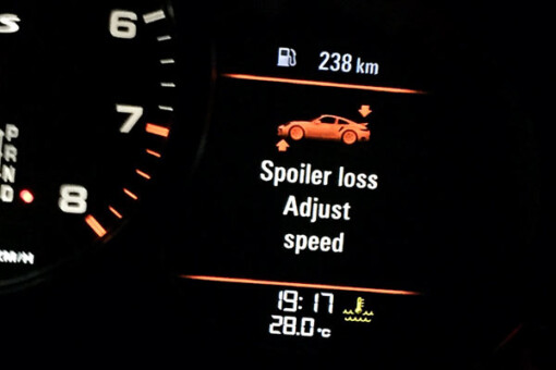 Porsche spoiler loss adjust speed message