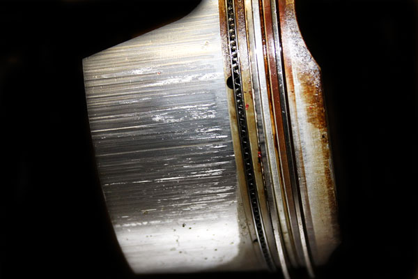 Piston from engine with cylinder bore scoring
